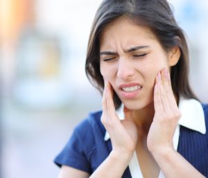 Stressed woman suffering tmj disorder